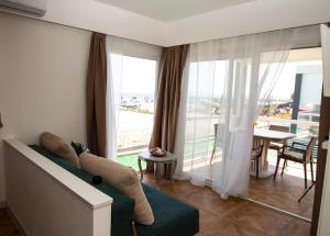 a living room with a couch and a large window at Villini Florence Boutique in Lido di Fermo
