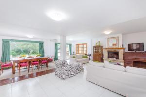 a living room with a couch and a table at YourHouse Can Marques villa in Palma de Mallorca