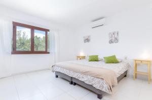a white bedroom with a bed and a window at YourHouse Can Marques villa in Palma de Mallorca +44 photos
