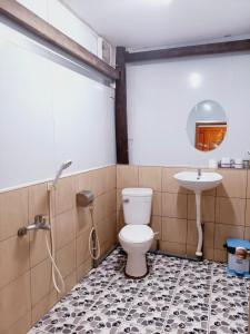 a bathroom with a toilet and a sink at Brown House Resort in Can Tho +67 photos