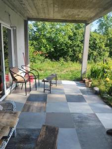 Un porche con dos bancos y una mesa. en Sunny Villa, en Belgrado