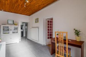 Una cocina con paredes blancas y techo de madera. en Fête des Lumières Lyon Séjour à Montluel, en Montluel 15 fotos más