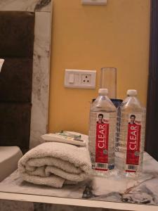 two bottles of water sitting on a table in front of a mirror at Bhagirathi Residency in Rishīkesh +3 photos