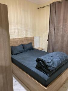 a bedroom with a bed with blue pillows at Résidence Atlantic in Agadir +38 photos