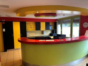a kitchen with a colorful counter in a room at Hôtel Arc-en-Ciel in Strasbourg