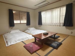 Postel nebo postele na pokoji v ubytování Yukiguni Base Hakuba