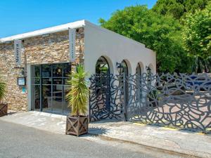 马赛Mercure Marseille Centre Bompard La Corniche的一栋带有大门的建筑，门前有一株植物