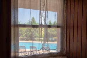 a window with a view of a swimming pool at Casa d'Aldeia in Rio Maior