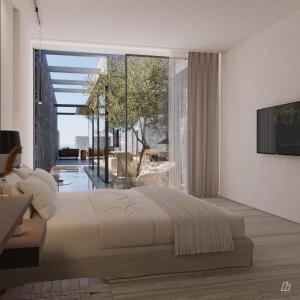 ein Schlafzimmer mit einem großen Bett und einem großen Fenster in der Unterkunft Kenshō Paros in Krotiri