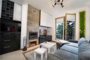 a living room with a couch and a fireplace at Stylish Cozy Studio with fireplace in Bansko