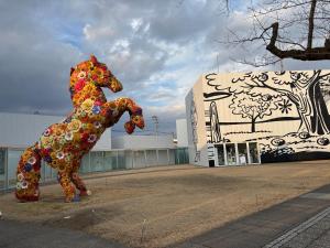 a statue of a horse in front of a building at Rental House Towada Yuzuriha Gallery Stay City in Towada