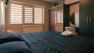 A bed or beds in a room at City Square Apartment