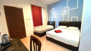 Φωτογραφία από το άλμπουμ του Capital O 91246 Tokman Inn σε Pantai Cenang