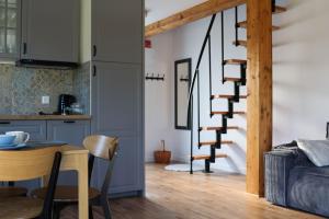 a kitchen and dining room with a table and a spiral staircase at Silva SPA in Goszczyce Średnie