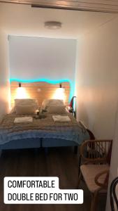 a bedroom with a bed with a double bed for two at Elf apartment in Rovaniemi