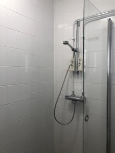 a shower with a shower head in a bathroom at Elf apartment in Rovaniemi
