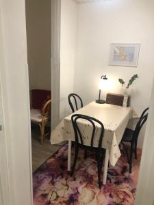 a table with chairs and a table with a lamp on it at Elf apartment in Rovaniemi