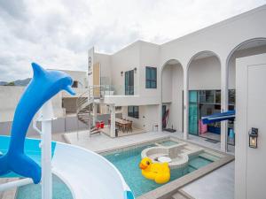 a house with a pool and a water slide at About P พูลวิลล่า ชะอำ in Ban Phu Wai