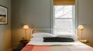 The Ipswich Inn في إبسوتش: غرفة نوم بسرير مع نافذة ومصباحين