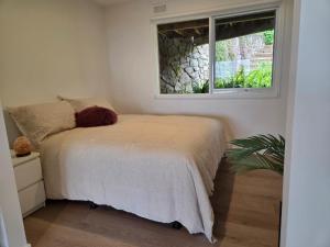 a bedroom with a bed and a window at Jalpari in McCrae