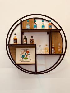 a shelf with bottles of alcohol on a wall at Le Rotte di Antonella in Lido di Ostia