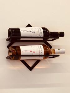 three wine bottles stacked on top of each other at Le Rotte di Antonella in Lido di Ostia
