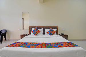 Ένα ή περισσότερα κρεβάτια σε δωμάτιο στο FabHotel JAS Holidays +18 φωτογραφίες