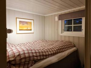 a bedroom with a bed and a window at Family Cabin With Stunning Views At Sjusjøen in Eggedal