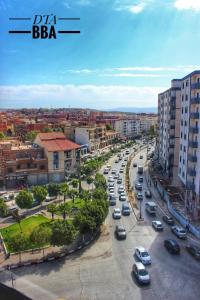 a busy city street with cars parked in traffic at El Fares Hôtel Spa & Conférences in Bordj Bou Arreridj