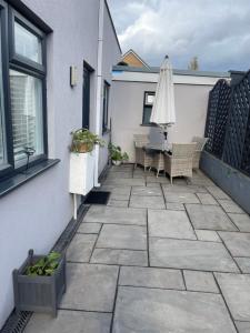 a patio with a table and an umbrella at Dream Flat in Bristol