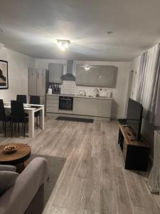a kitchen and living room with a couch and a table at Dream Flat in Bristol +3 photos