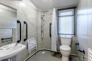 a bathroom with a toilet and a sink at Landal Kenwick Woods in Louth +26 photos