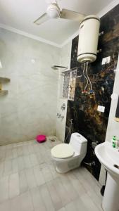 a bathroom with a toilet and a sink at Gavari India's Delhi Hostel in New Delhi