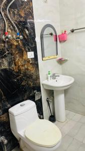 a bathroom with a toilet and a sink at Gavari India's Delhi Hostel in New Delhi +6 photos