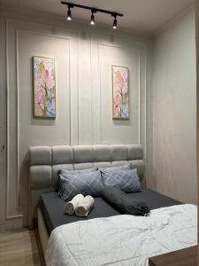a bedroom with a bed with two towels on it at ADS House Padalarang - Guesthouse Aesthetic in Padalarang
