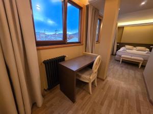 a room with a desk and a window and a bed at Hotel Santa Catalina by Bossh Hotels! in A Coruña