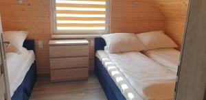 a small room with two beds and a window at Nautica in Gąski