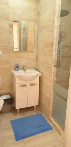 a bathroom with a sink and a shower at Nautica in Gąski +21 photos