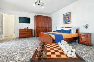 a bedroom with a chess board and a bed at Estate4home - Villa Luisa Jacuzzi&Pool in SantʼAgata sui Due Golfi +48 photos