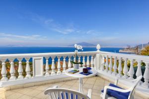 a balcony with a white fence and a table and chairs at Estate4home - Villa Luisa Jacuzzi&Pool in SantʼAgata sui Due Golfi