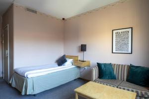 um quarto com uma cama, um sofá e uma mesa em Best Western Hotell Kramm em Kramfors mais 118 fotografias