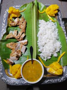 Panorama de Argao Boutique Hotel في Argao: صحن من الطعام به رز ولحم وصحن من الشوربة