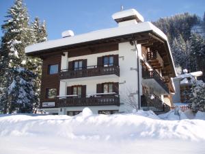 un grande edificio con neve di fronte di Garnì BUCANEVE Bed & Breakfast a Madonna di Campiglio