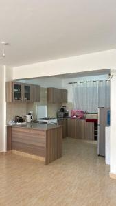 a large kitchen with wooden cabinets and a counter top at Comfort meets convenience 3BR by Airport & SGR in Nairobi