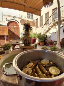 a metal pot of food with lemon slices in it at Yılmazhan Konağı Butik Otel in Gaziantep