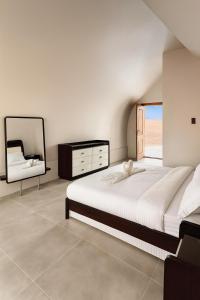 BadīyahにあるGalaxy chaletの大きなベッドと鏡のある寝室