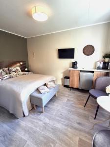 a bedroom with a large bed and a tv at Kattugglans Gästrum 1 in Ljungby