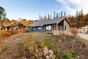 a house sitting on top of a dirt field at Modern Mountain Cabin Near Norefjell in Eggedal