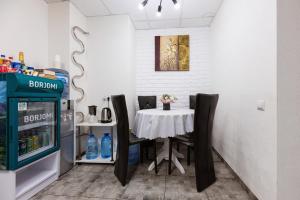 a dining room with a table and a soda machine at SkyHome na Nauky in Kyiv