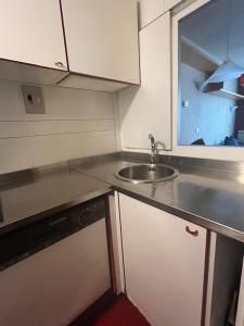 a small kitchen with a sink and a counter top at Condominio La Grand'Ourse - Cervinia in Breuil-Cervinia